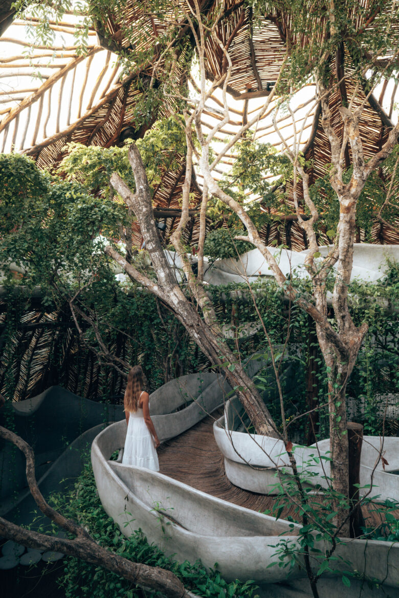 A woman is standing in a tree house.