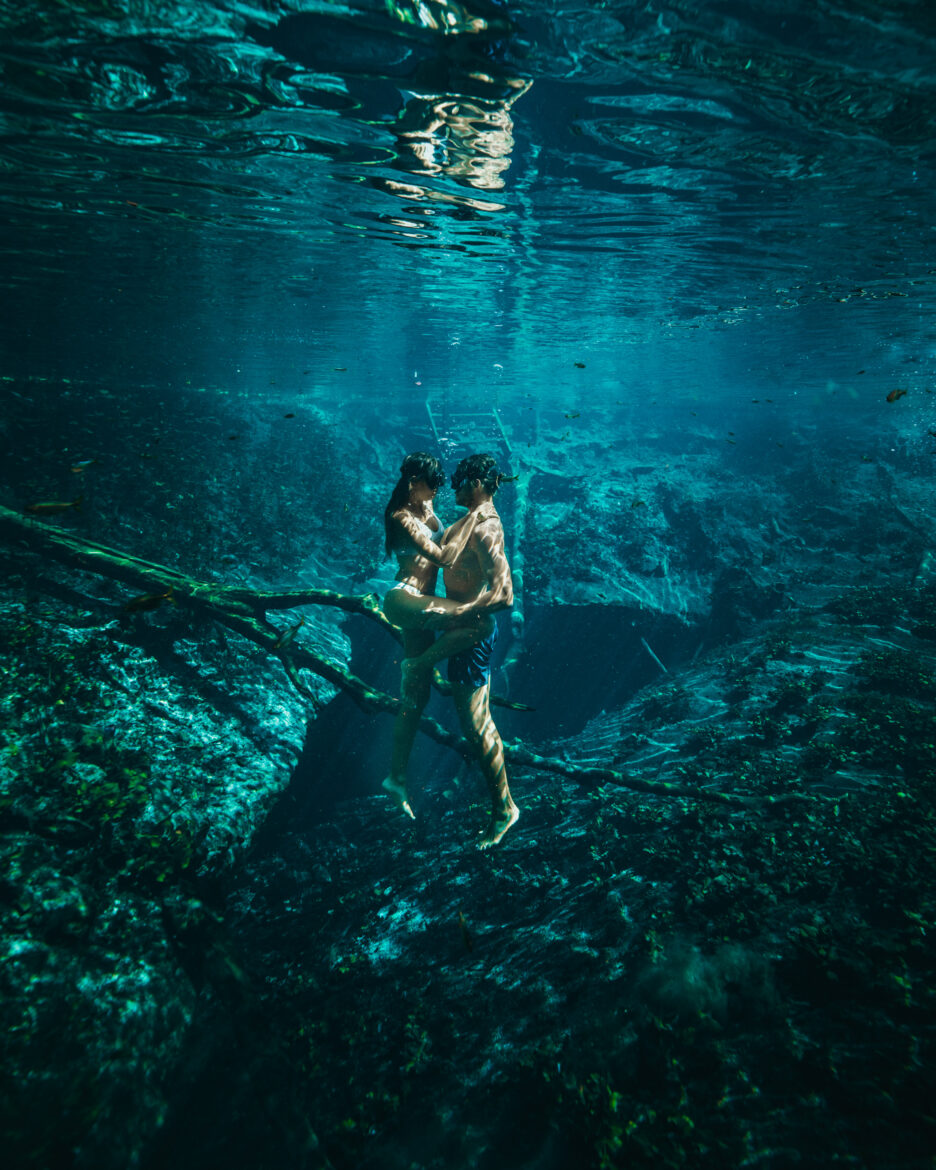 A couple is floating in the water of a cent