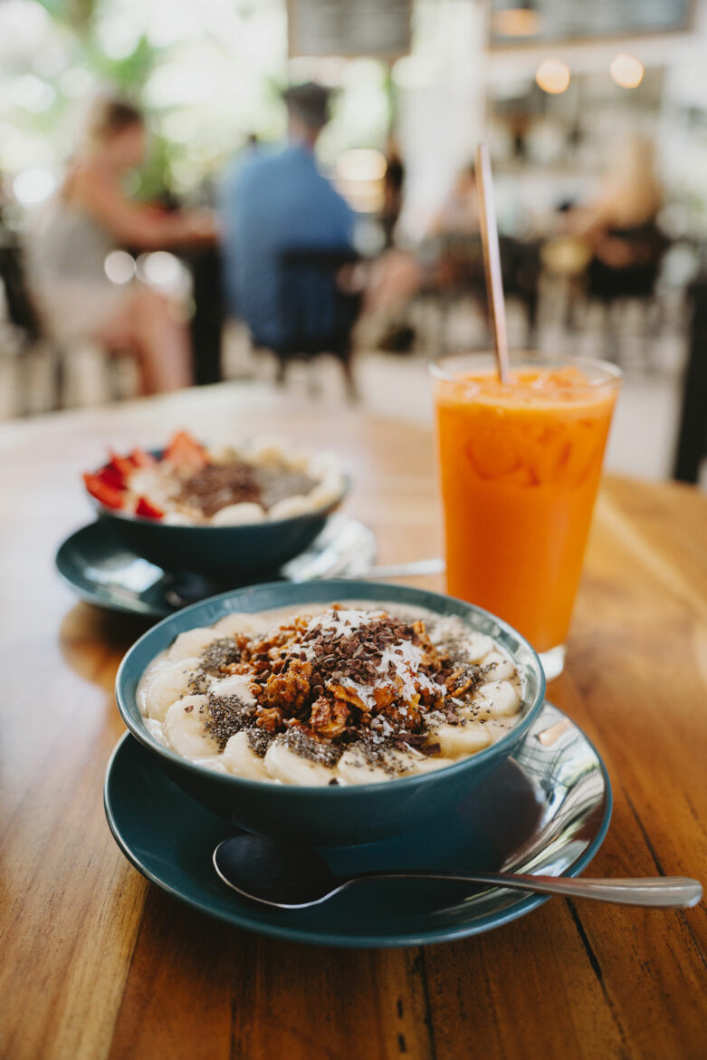 Two bowls of food on a table.