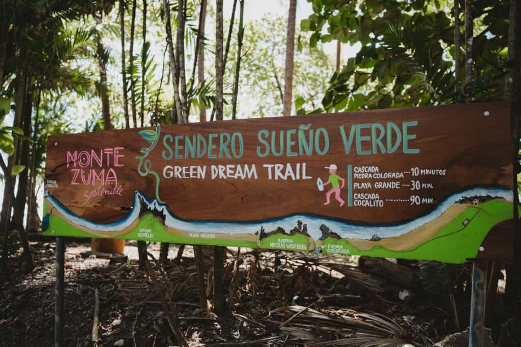 A sign for the green manzana trail in Montezuma, Costa Rica.