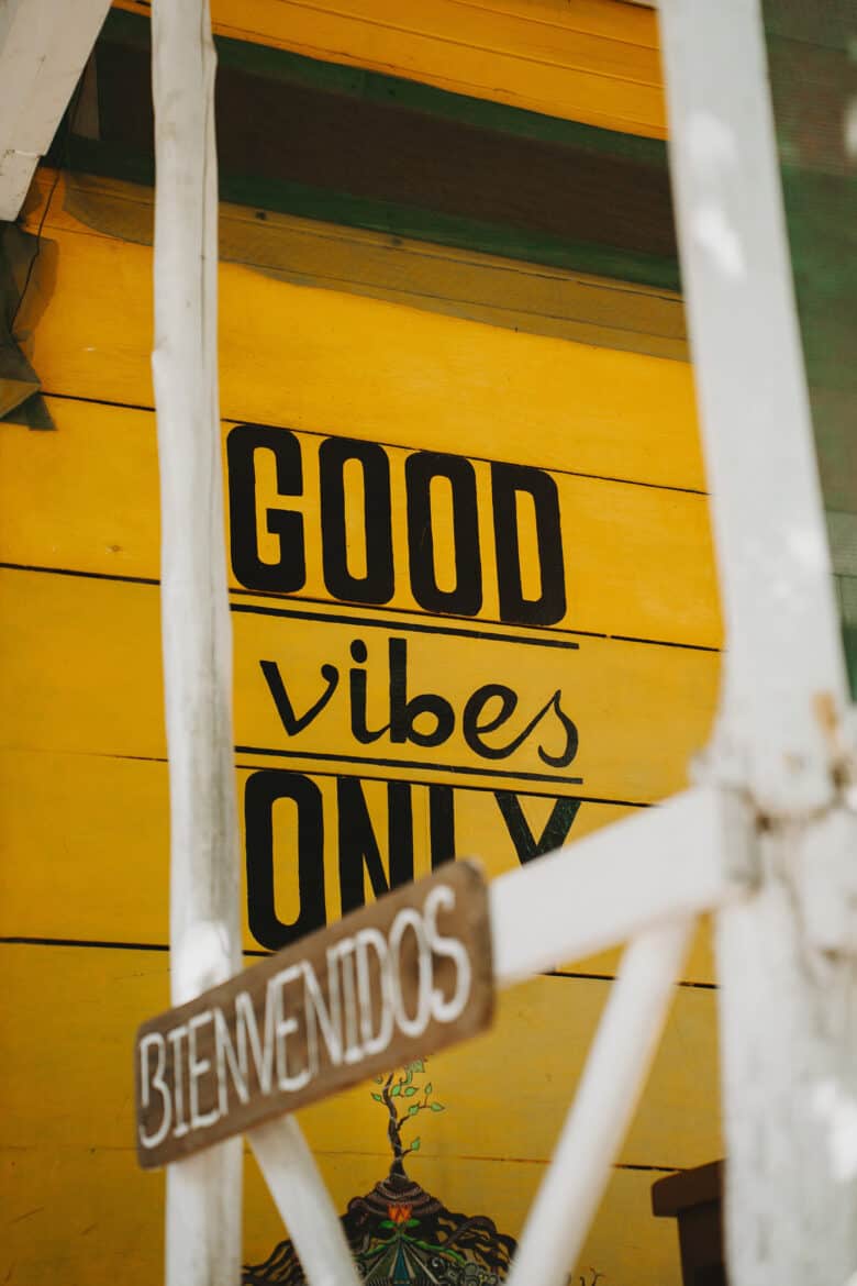 In the coastal town of Montezuma, Costa Rica, stands a vibrant yellow building adorned with a sign that joyfully declares "good vibes only.
