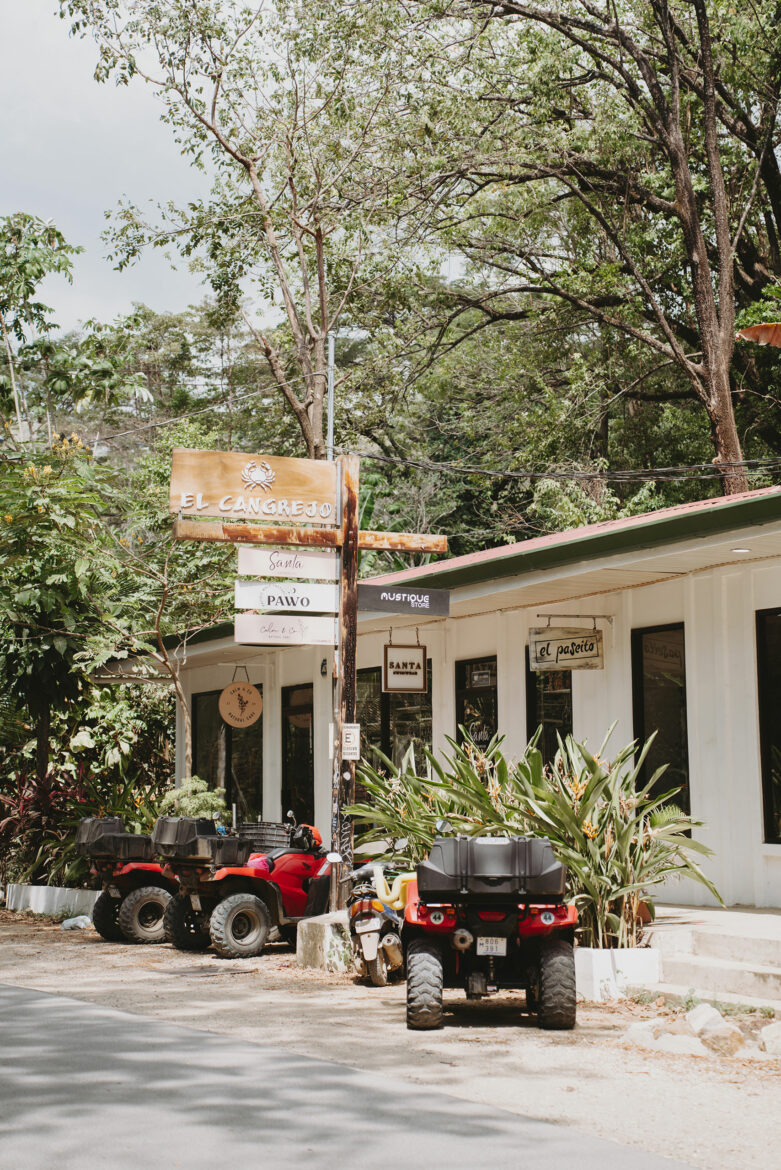 A group of four wheelers parked in front of a building.